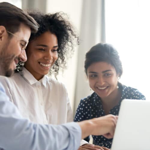 Diverse Happy Interns Learning New Computer Software Listening To Mentor