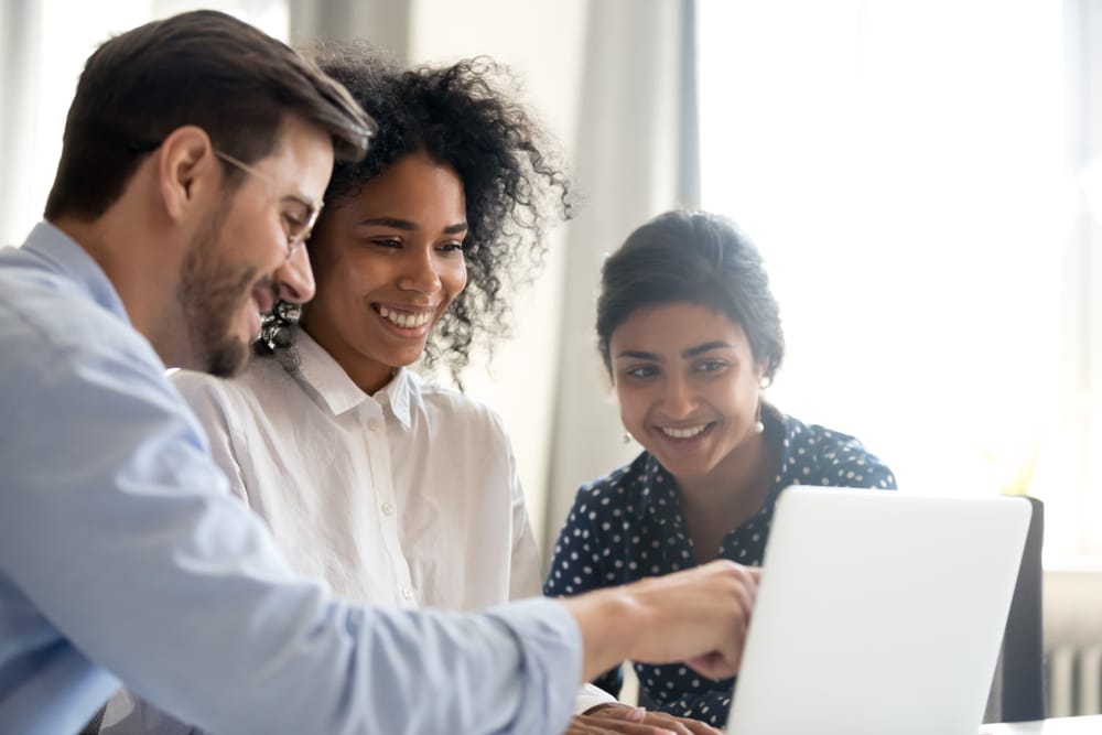 Diverse Happy Interns Learning New Computer Software Listening To Mentor