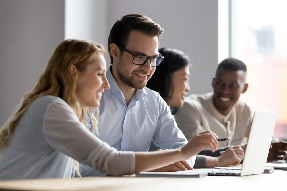 Employees Discussing Online Project Showing Computer Presentation